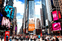 A vibrant Times Square scene featuring a towering San Diego tourism digital billboard with the message “San Diego is the place to show it,” surrounded by colorful advertisements, skyscrapers, pedestrians, and city traffic.