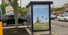 An ad for a sustainable clothing company. It's displayed on a bus shelter with advertising managed by ATA Outdoor.