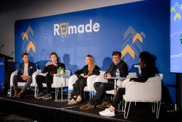Panel discussion at Mumbrella REmade 2026, with five speakers seated on stage in front of a blue REmade backdrop.