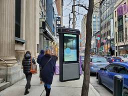 A woman looks at a Campsite digital out-of-home screen