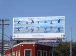 A billboard from Apple's &quot;Shot on iPhone&quot; campaign. It shows a group of people doing a timed shot where they all jumped in the air. It's a good example of how Apple used attractive imagery shot on iPhones to create billboards people notice.
