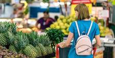 A woman shopping for produce in the supermarket.